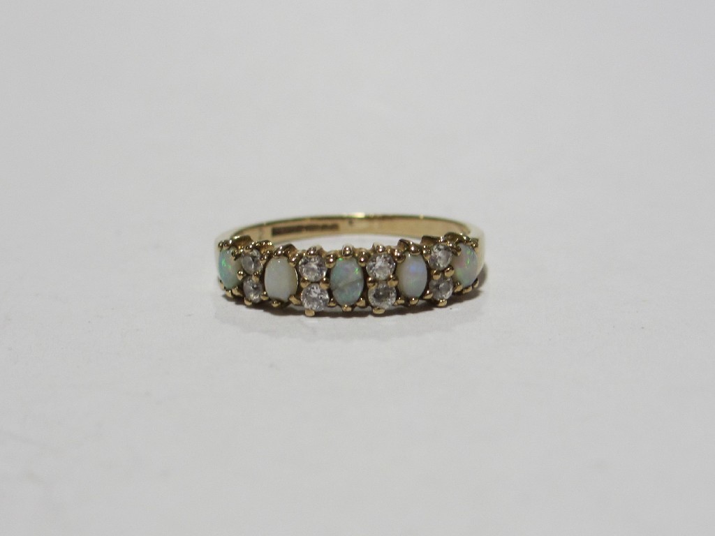 Appraisal: Nine carat gold opal and cz set half hoop ring