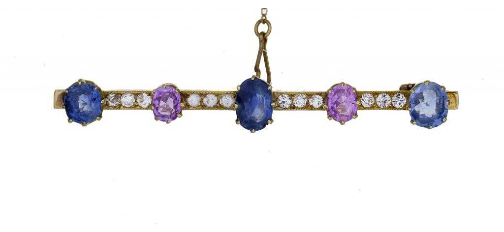 Appraisal: A SAPPHIRE BAR BROOCH with three blue and two pink