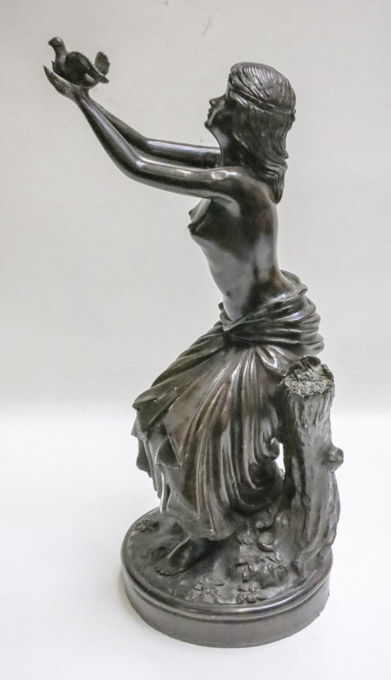 Appraisal: NEOCLASSIC BRONZE FIGURAL SCULPTURE a semi-clad woman releasing a dove