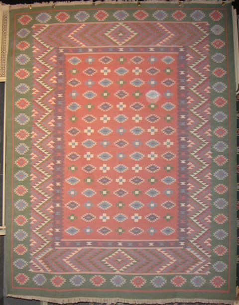 Appraisal: DHURRIE TRIANGLED DESIGNED RUG WITH LIGH GREEN BORDER feet inches