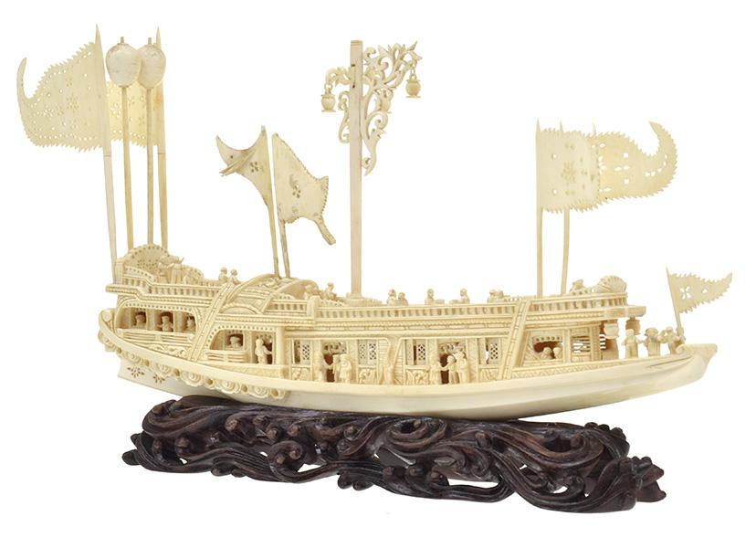 Appraisal: A CHINESE IVORY CARVING OF A JUNK housed on naturalistic