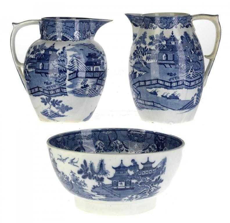 Appraisal: TWO MINTON BLUE PRINTED PEARLWARE HERMIT AND BOAT PATTERN JUGS