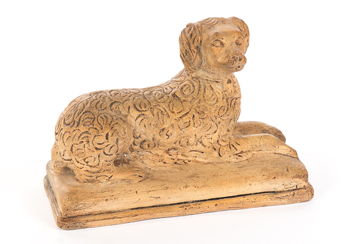 Appraisal: AMERICAN POTTERY DOG Second half- th century white clay Reclining