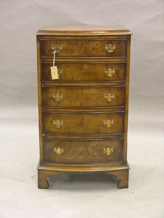 Appraisal: A reproduction burr walnut veneered chest bow fronted with five