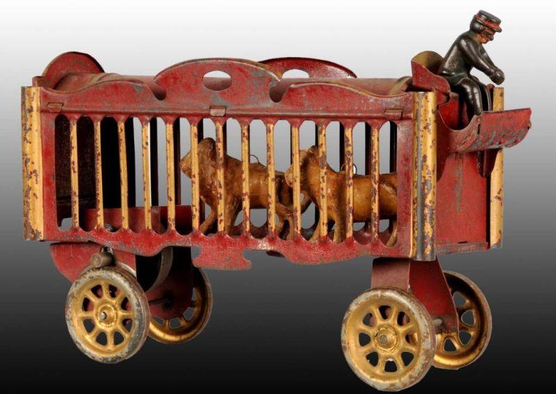 Appraisal: Red Gold Tin Circus Cage Wagon Toy Description A hill