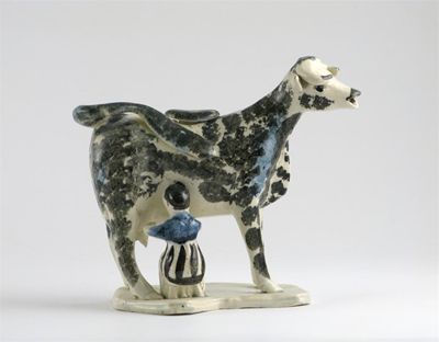 Appraisal: A pearlware cow creamer and cover sponged in black and