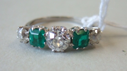 Appraisal: An emerald and diamond set five stone ring claw set