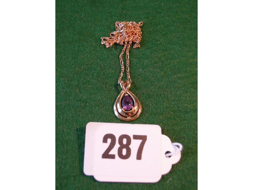 Appraisal: An ovoid amethyst and ct yellow gold pendant suspended from