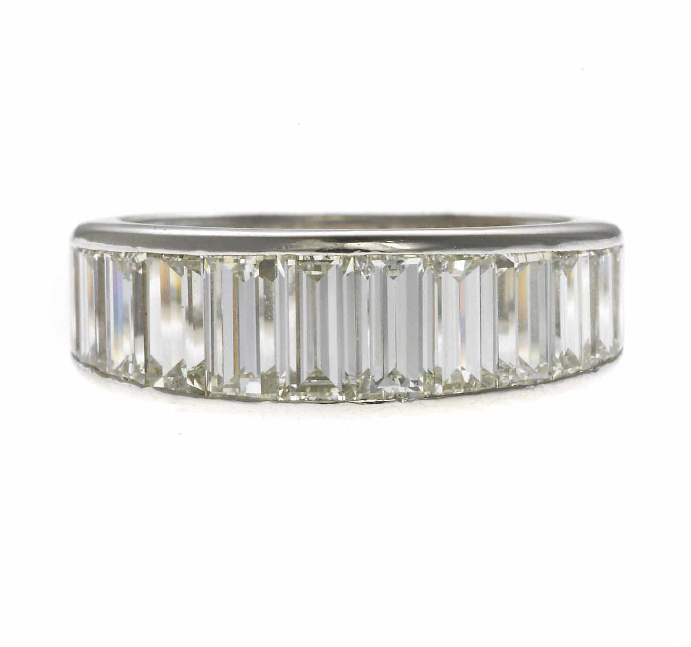 Appraisal: A diamond eternity band composed of baguette-cut diamonds estimated total