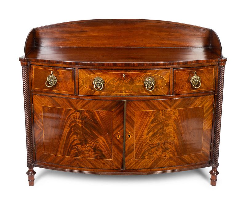 Appraisal: A Regency Carved and Figured Mahogany Satinwood Inlaid Bow-front Dresser