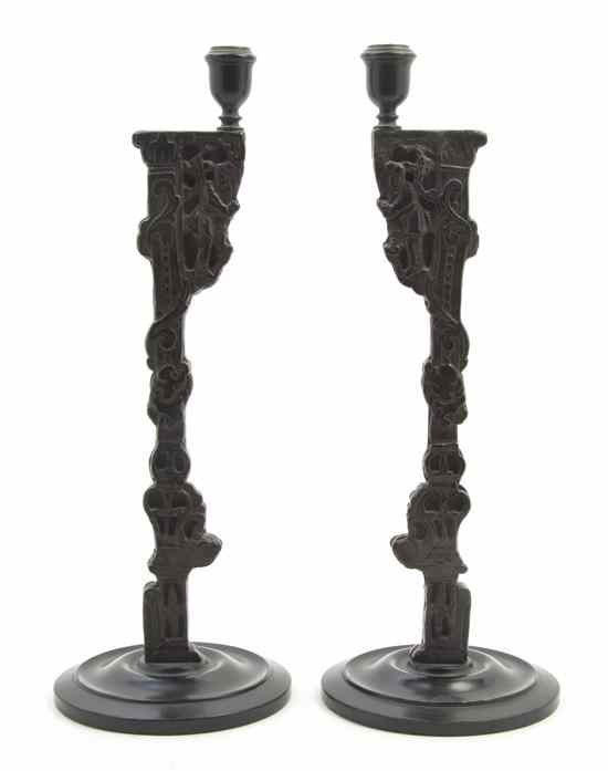 Appraisal: A Pair of Chinoiserie Carved Ebonized Wood Candlesticks the standards