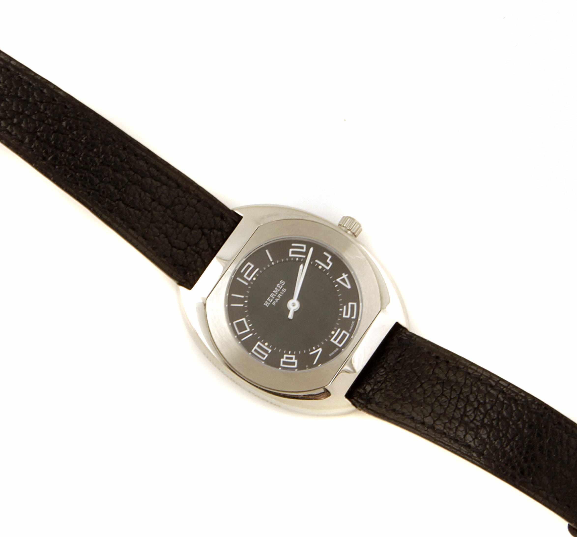 Appraisal: A stainless steel and black leather strapped wristwatch Hermes with