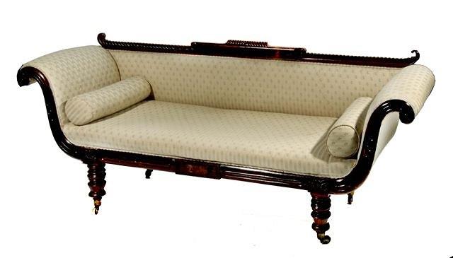 Appraisal: A REGENCY MAHOGANY DOUBLE ENDED SOFA with a carved gadrooned