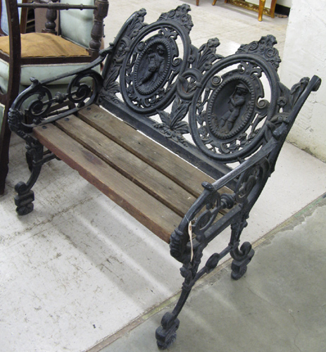 Appraisal: VICTORIAN STYLE CAST IRON SETTEE with double pictorial oval medallion