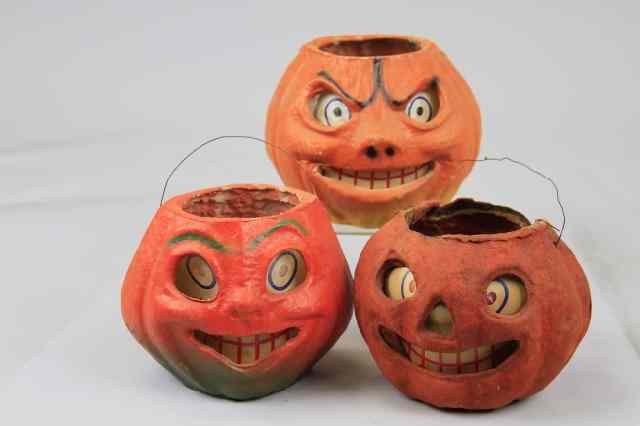 Appraisal: THREE PAPER FACE JACK-O-LANTERS Three paper face pulp jack-o-lanterns all