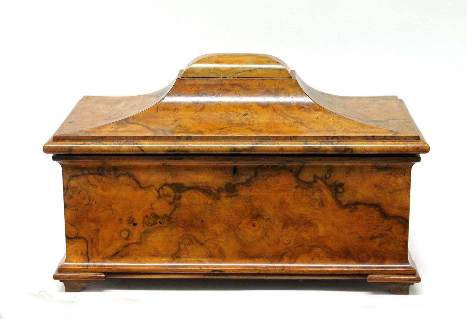 Appraisal: A late Regency figured walnut sarcophagus tea caddy with twin