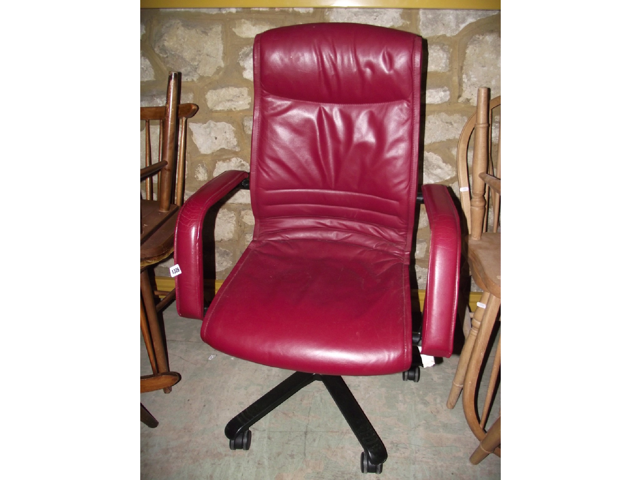 Appraisal: A modern adjustable swivel office chair with maroon coloured faux