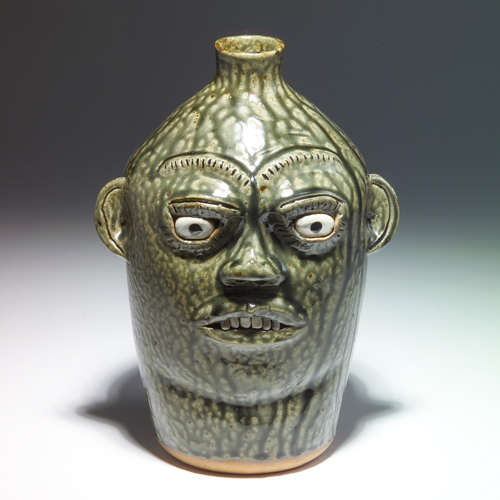 Appraisal: A G MEADERS Stoneware face jug with six teeth covered