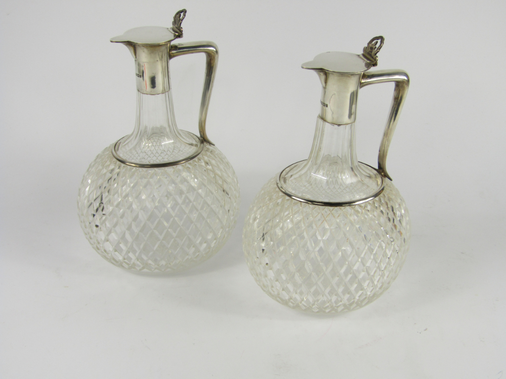 Appraisal: A pair of Edward VII cut glass claret jugs with