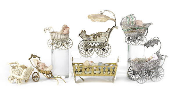 Appraisal: Four miniature soft metal doll carriages Including painted white and