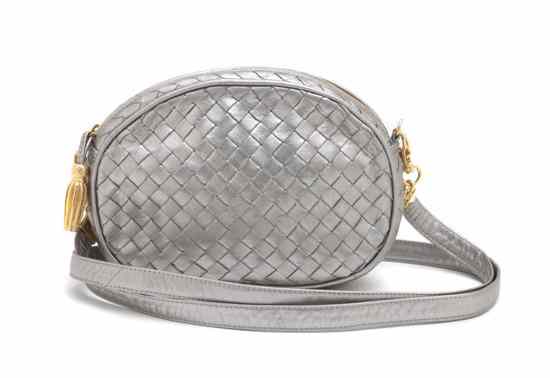 Appraisal: A Bottega Veneta Silver Metallic Woven Clutch with tassel motif