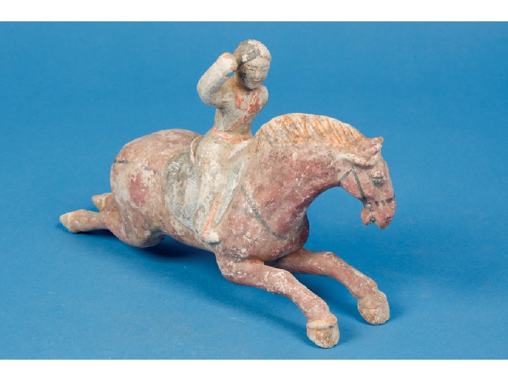 Appraisal: A TANG STYLE FIGURE of a horse and rider with