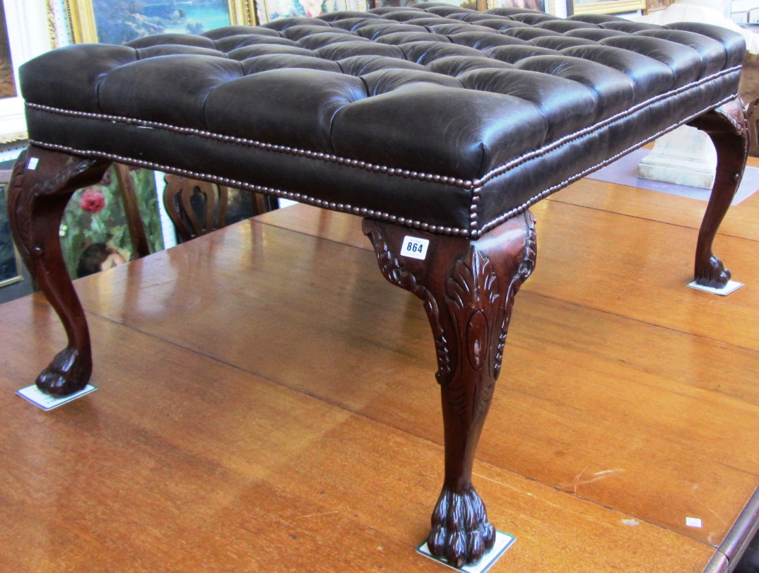 Appraisal: A large footstool the over stuffed button brown leather top