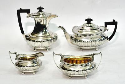 Appraisal: AN EDWARDIAN FOUR PIECE TEA SET of half fluted oblong