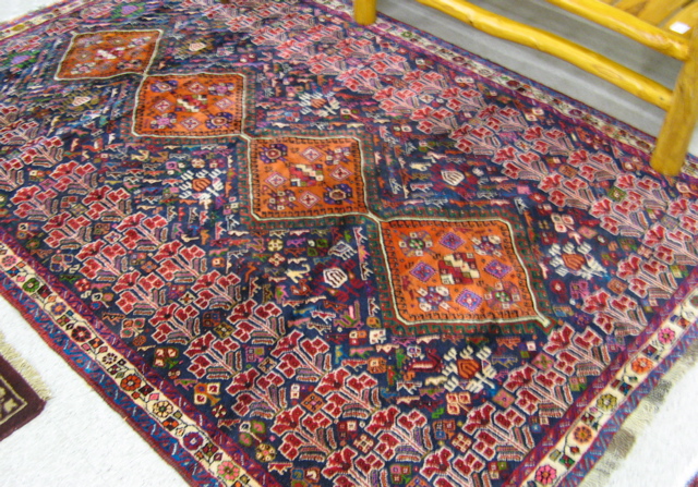 Appraisal: PERSIAN TRIBAL CARPET centering a single column of four diamond