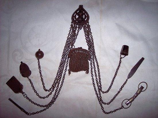 Appraisal: A Victorian cut steel chatelaine with pierced clip and suspension