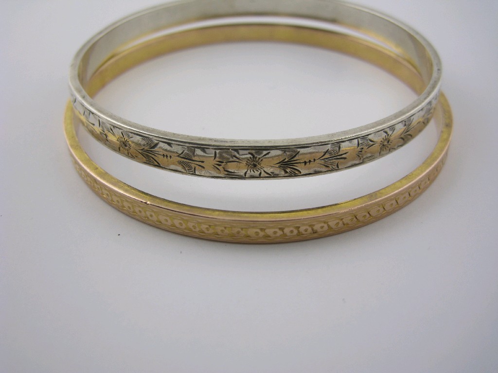 Appraisal: A 's ct gold Slave Bangle with engraved decoration and