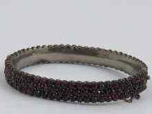 Appraisal: A Victorian garnet bangle set in white metal c Approx