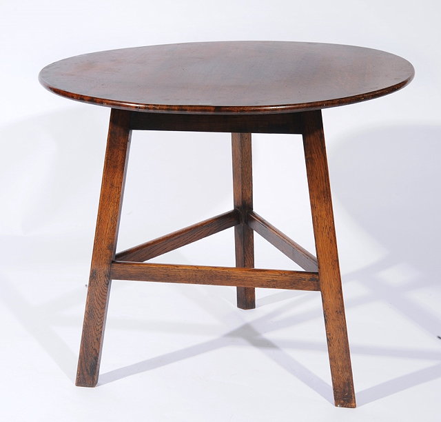 Appraisal: A HEALS OAK CRICKET TABLE with circular plank top on