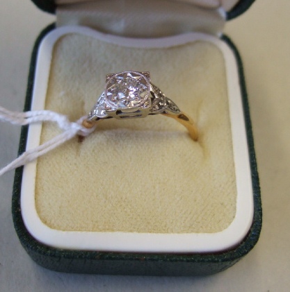 Appraisal: A gold and platinum diamond set single stone ring mounted