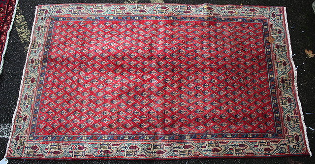 Appraisal: A HAMADAN RED GROUND RUG with central geometric decoration within