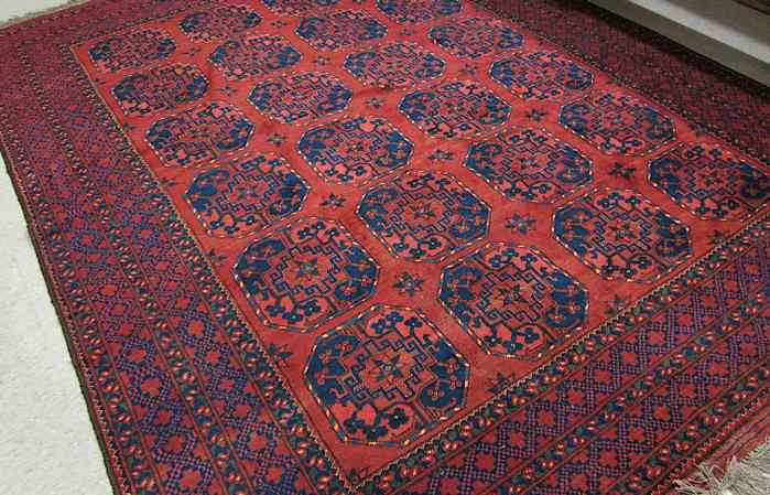 Appraisal: AFGHAN ERSARI CARPET featuring a field of large rectangular gols