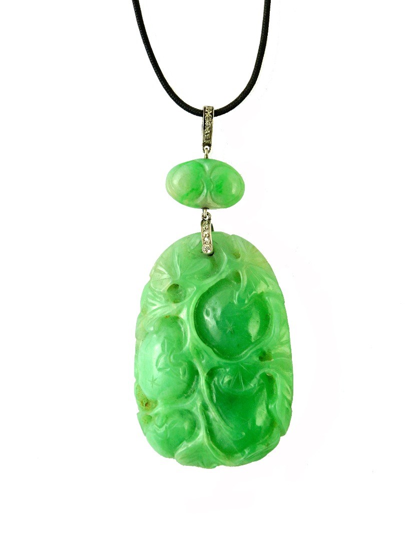 Appraisal: A Chinese carved jade and diamond set pendant the principal