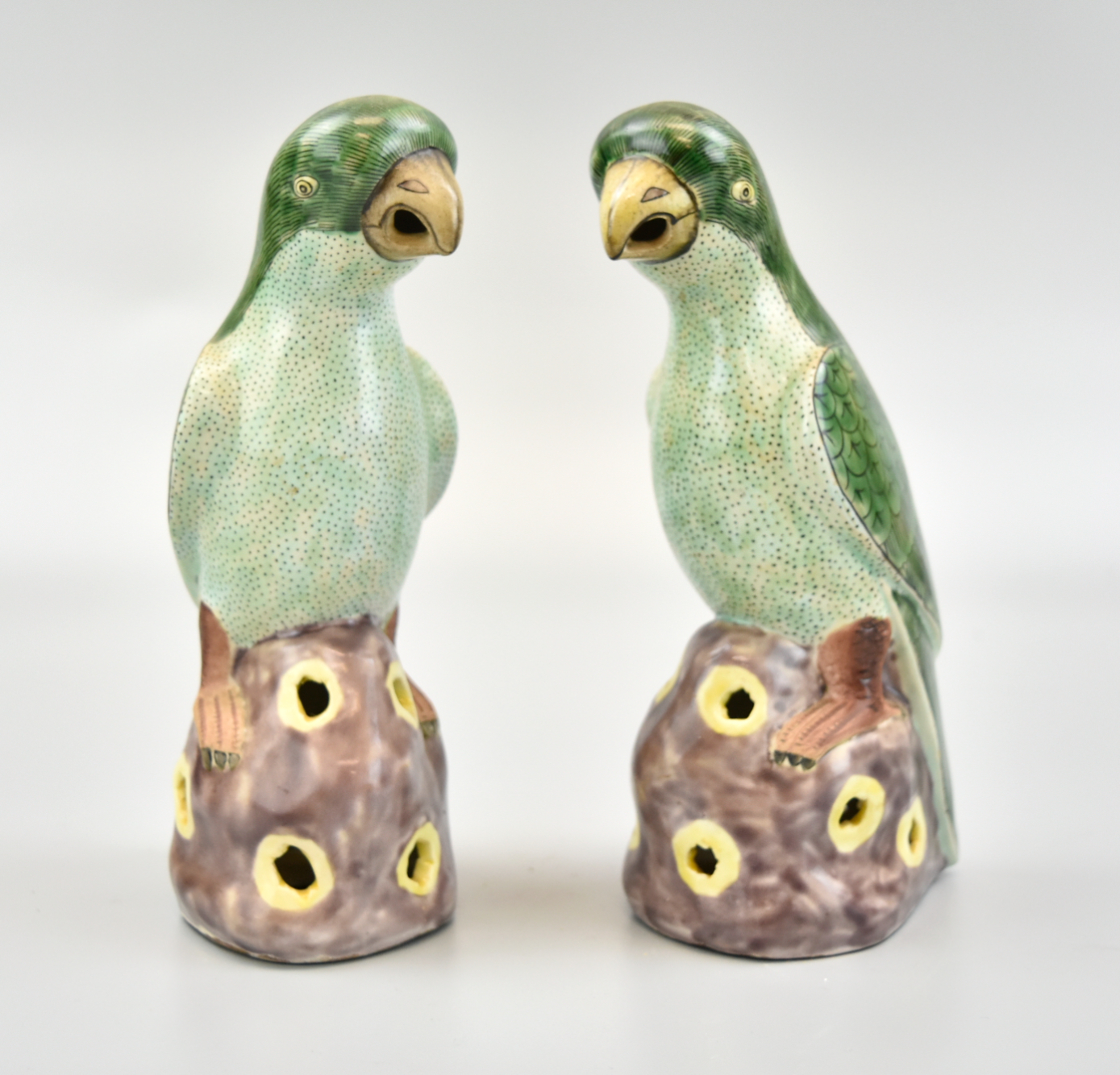 Appraisal: A pair of th C famille rose parrot perched on