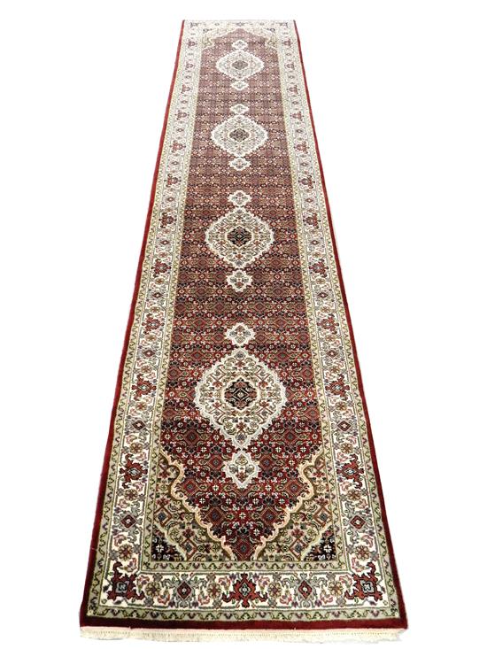 Appraisal: RUG Tabriz Mahi runner medallioins on red ground ivory border