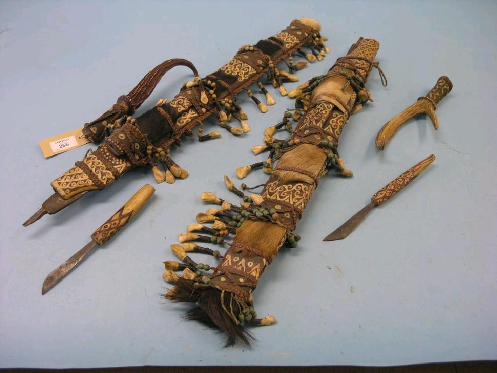 Appraisal: Two south-east Asian sword sheaths painted wood with applied hair