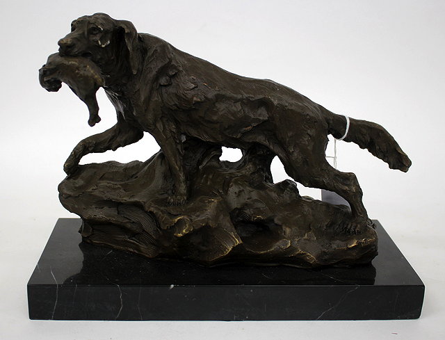 Appraisal: A CONTEMPORARY BRONZE SCULPTURE OF A HUNTING DOG holding its