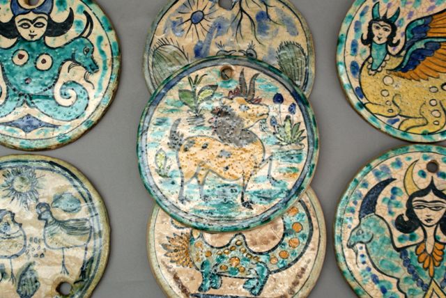 Appraisal: Seven Qajar glazed pottery circular tiles each enriched with hand