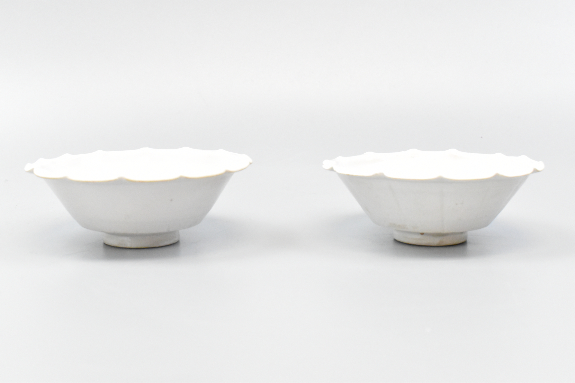 Appraisal: Two Chinese white glazed bowls From a short foot the