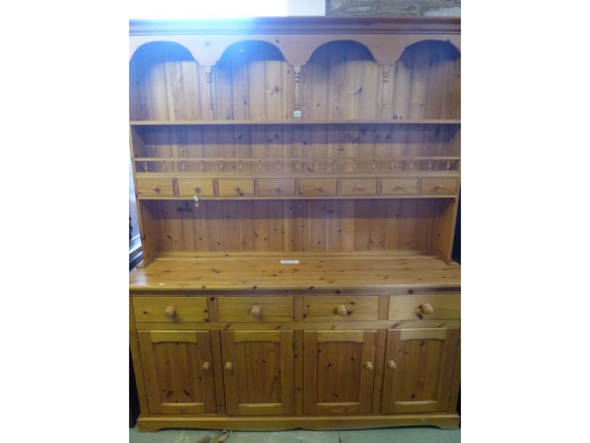 Appraisal: A large stripped pine farmhouse kitchen dresser the base enclosed