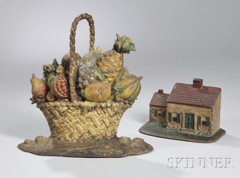 Appraisal: Two Painted Cast Iron Doorstops a basket of fruit and