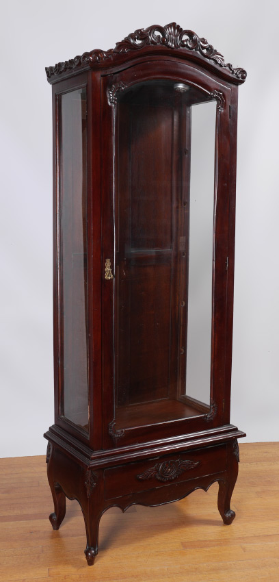 Appraisal: CARVED TALL VITRINE DISPLAY CABINET Arched carved foliate motif crest