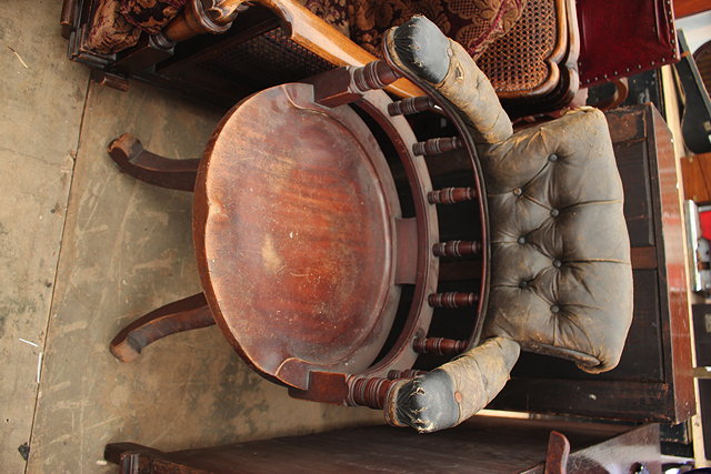 Appraisal: AN EARLY TH CENTURY HARDWOOD LEATHER UPHOLSTERED DESK CHAIR the