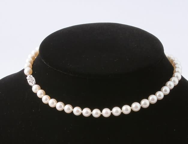 Appraisal: KW gold clasp long strand of mm round pearls gms