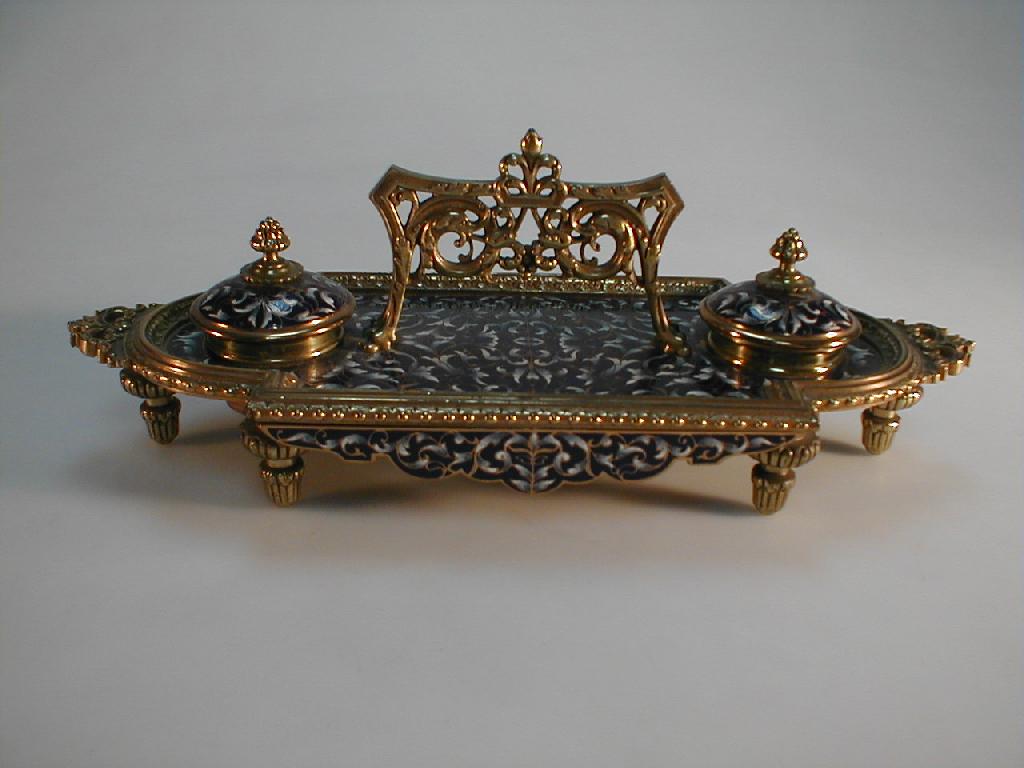 Appraisal: A cast brass champleve desk stand of oblong form with