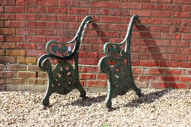 Appraisal: A PAIR OF VICTORIAN CAST IRON GREEN PAINTED BENCH ENDS